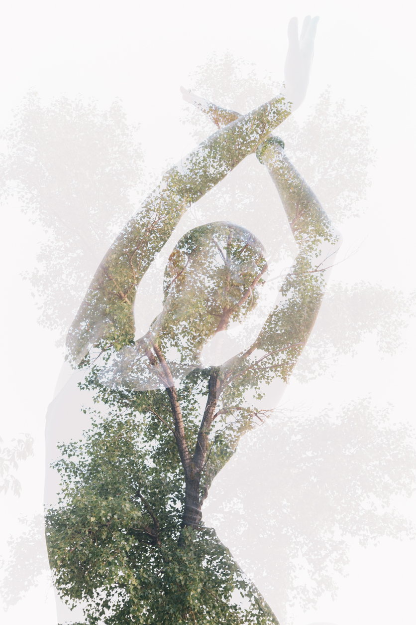 Double exposure portrait of dancing woman combined with photograph of tree